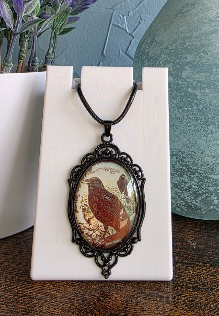 Antique pendant necklace with image of raven or crow gothic mystic