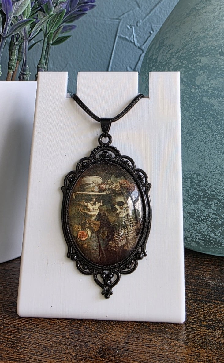 Antique pendant necklace with image of skeleton couple gothic mystic