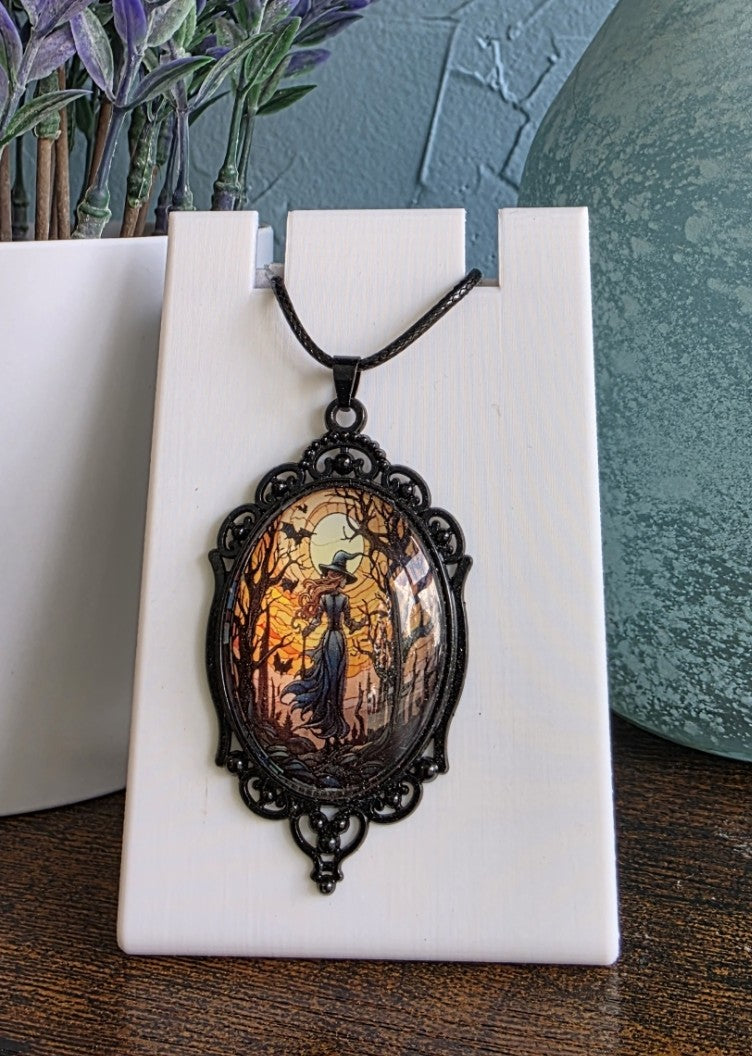 Antique pendant necklace featuring a witch in the woods gothic mystic