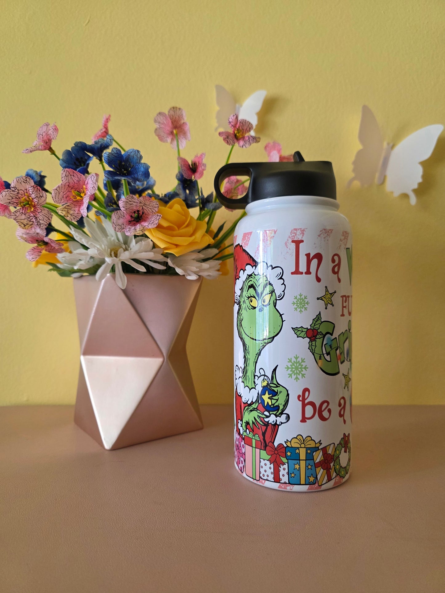 How the Grinch Stole Christmas Cindy Lou Who Stainless Steel Water Bottle on a table with yellow background
