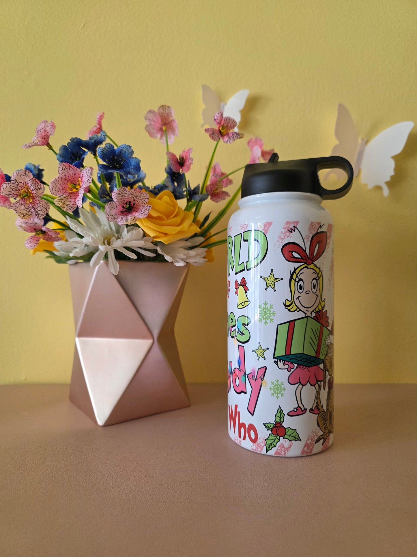 How the Grinch Stole Christmas Cindy Lou Who Stainless Steel Water Bottle on a table with yellow background