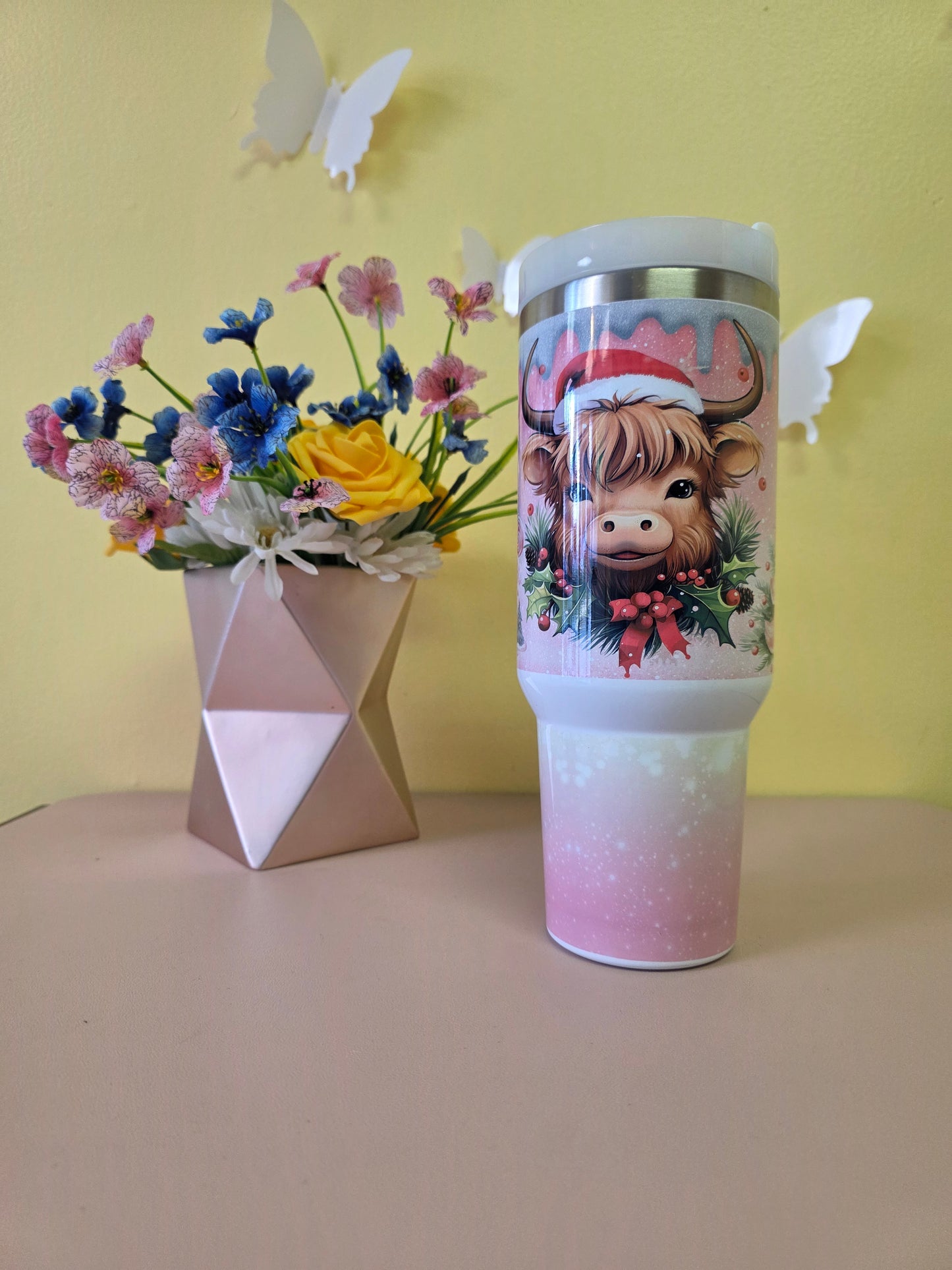 Christmas Highland Cow Santa 40 Ounce Stainless Steel Tumbler Pink on a yellow background