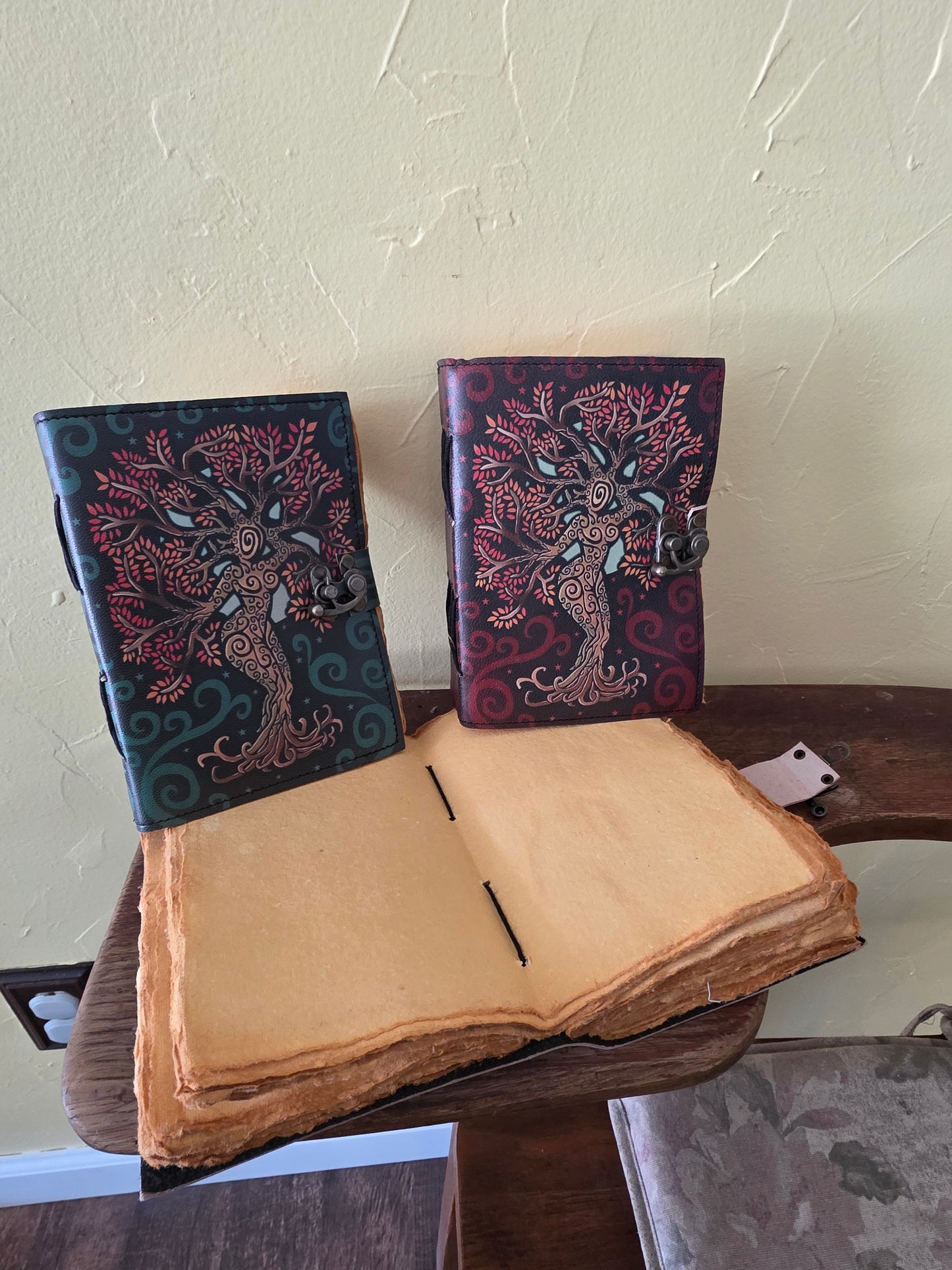 Two decorative books with intricate designs on a light-colored surface.
