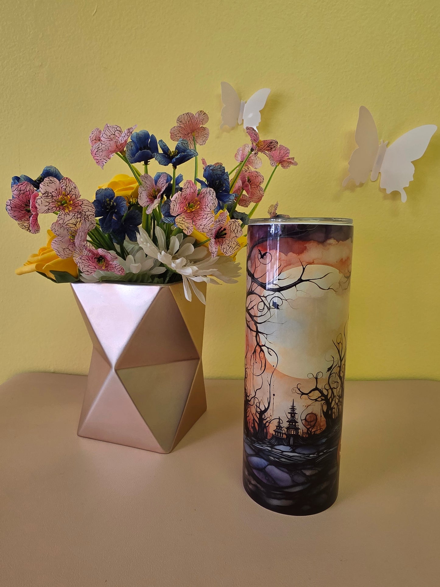 Halloween stainless steel tumbler twenty ounces with black and orange graveyard and pumpkin design