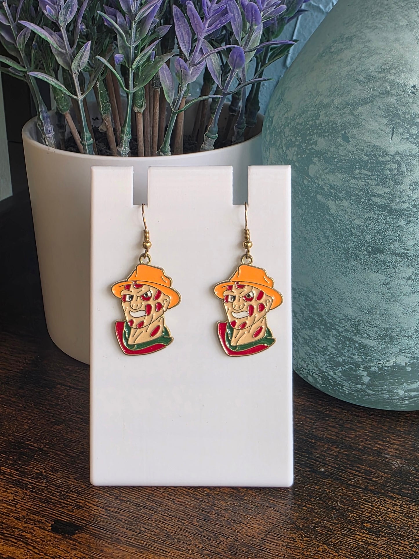 Earrings depicting cartoon Freddy Krueger character.