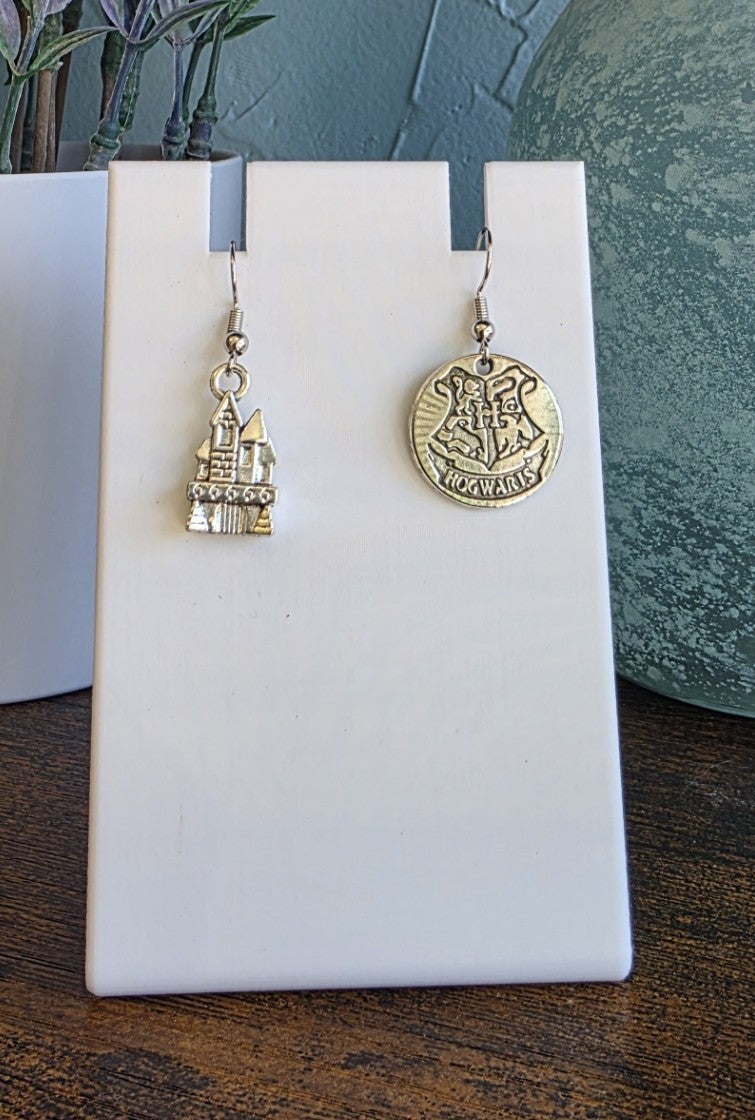Silver mismatch earrings with Castle and Hogwarts logo Harry Potter