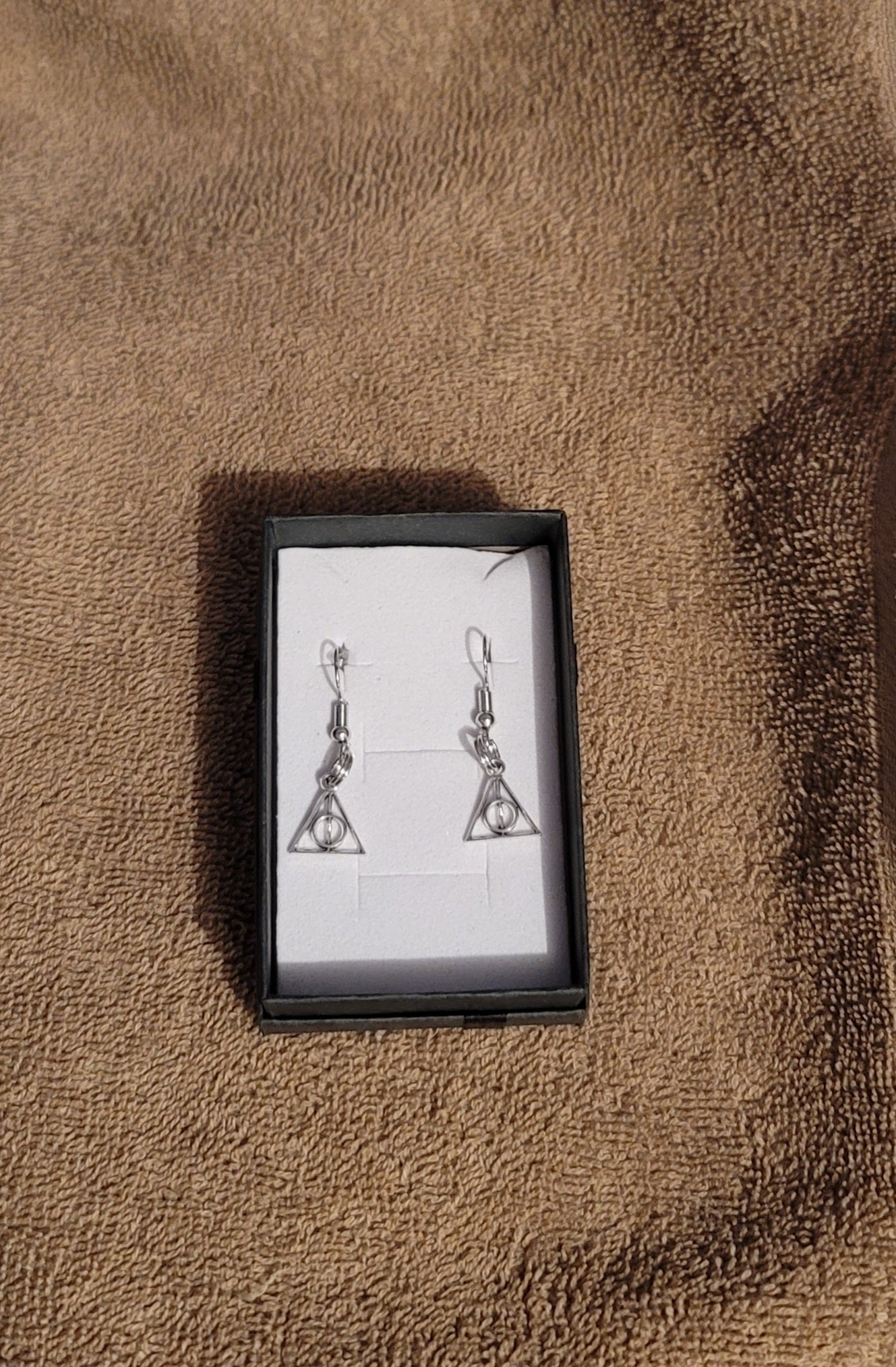 Harry Potter silver Deathly Hallows earrings.