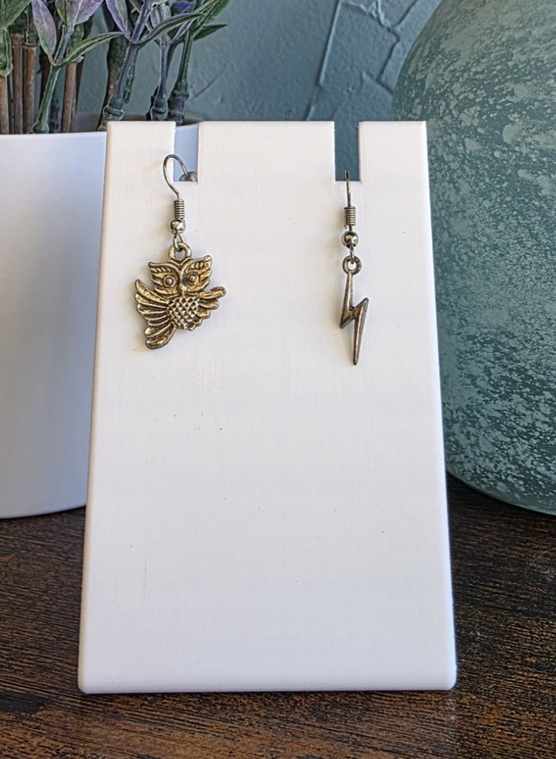 Harry Potter silver mismatch earrings with Hedwig and lightning bolt.