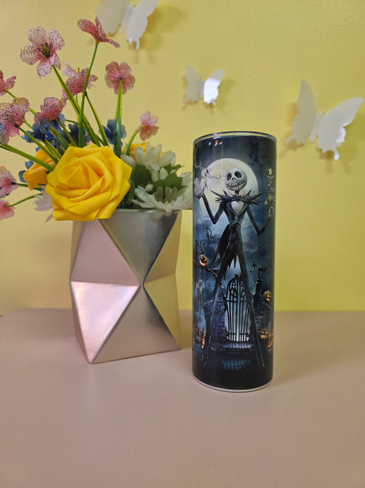 Jack Skellington Halloween Tumbler on a pink surface with yellow background.