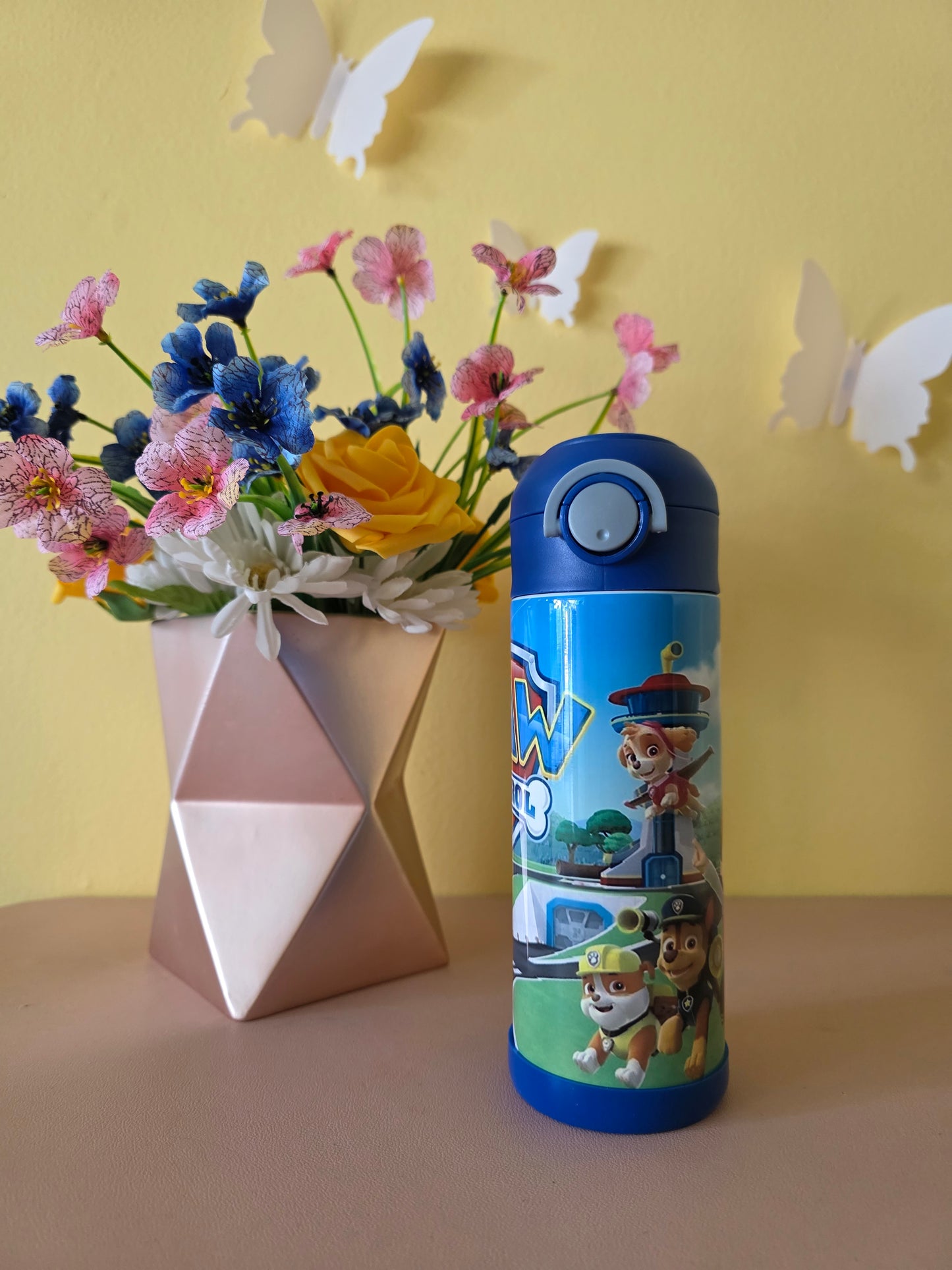 Paw Patrol Kids Tumbler on a table with yellow background