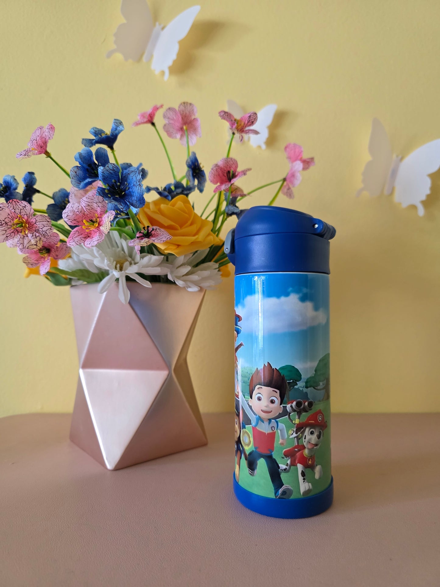 Paw Patrol Kids Tumbler on a table with yellow background
