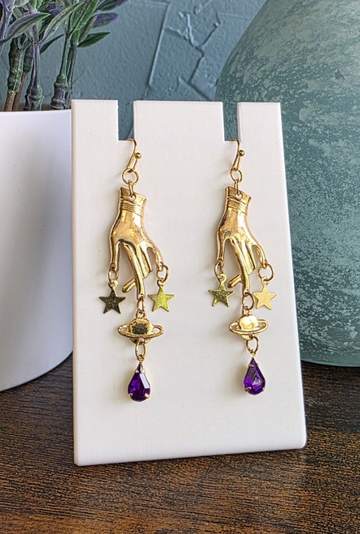 Gold hand shaped earrings with star and purple drop dangles gothic mystic