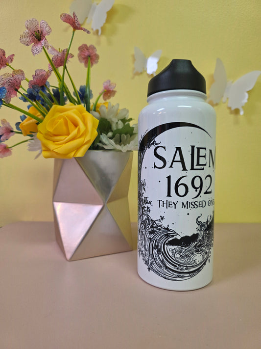 Salem Witch Trials water bottle tumbler on a pink surface with yellow background
