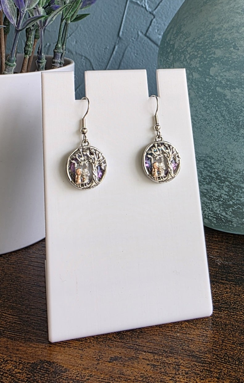 silver tree of life earrings with sisters sitting in a swing