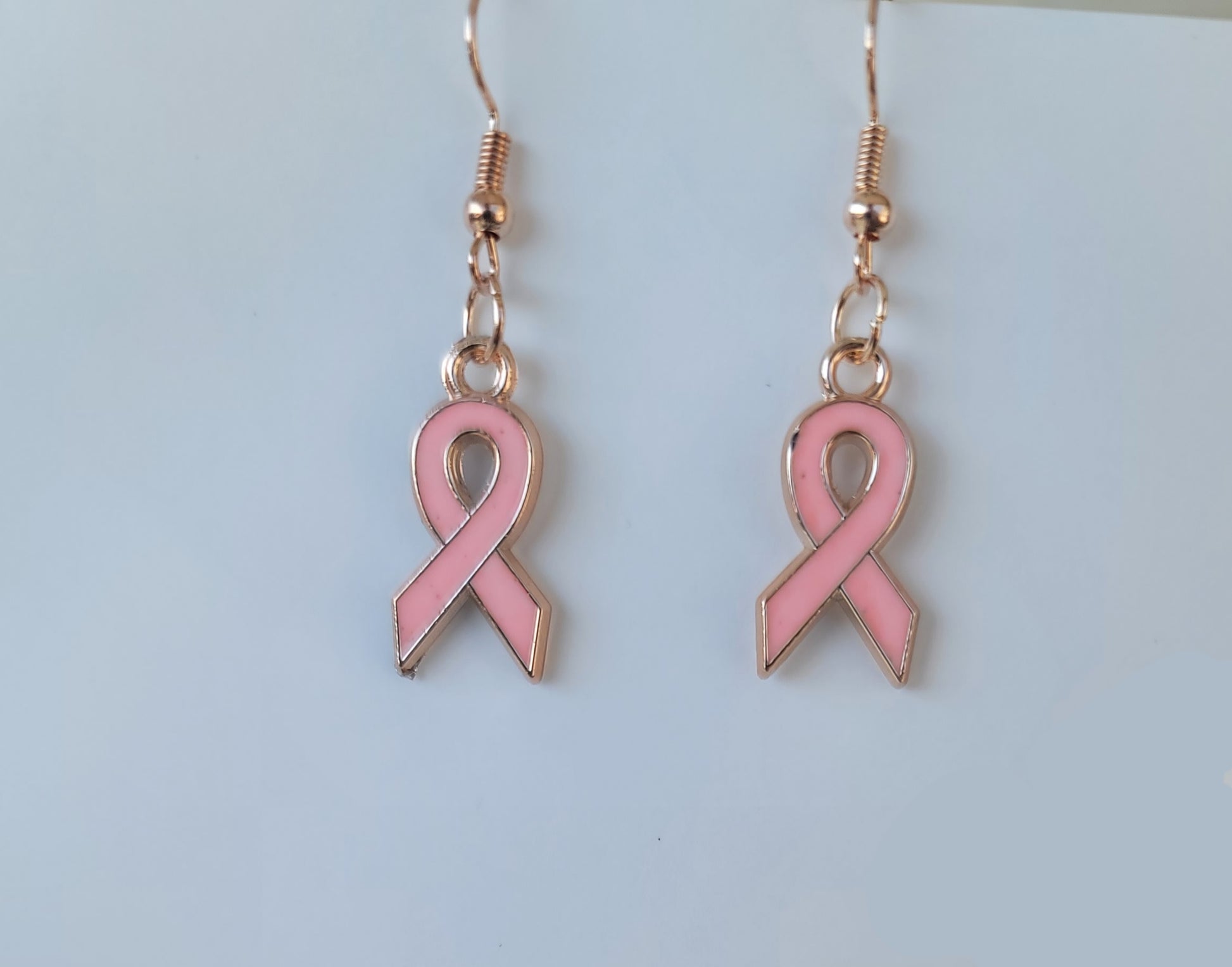 Small pink ribbons for breast cancer awareness with gold finish