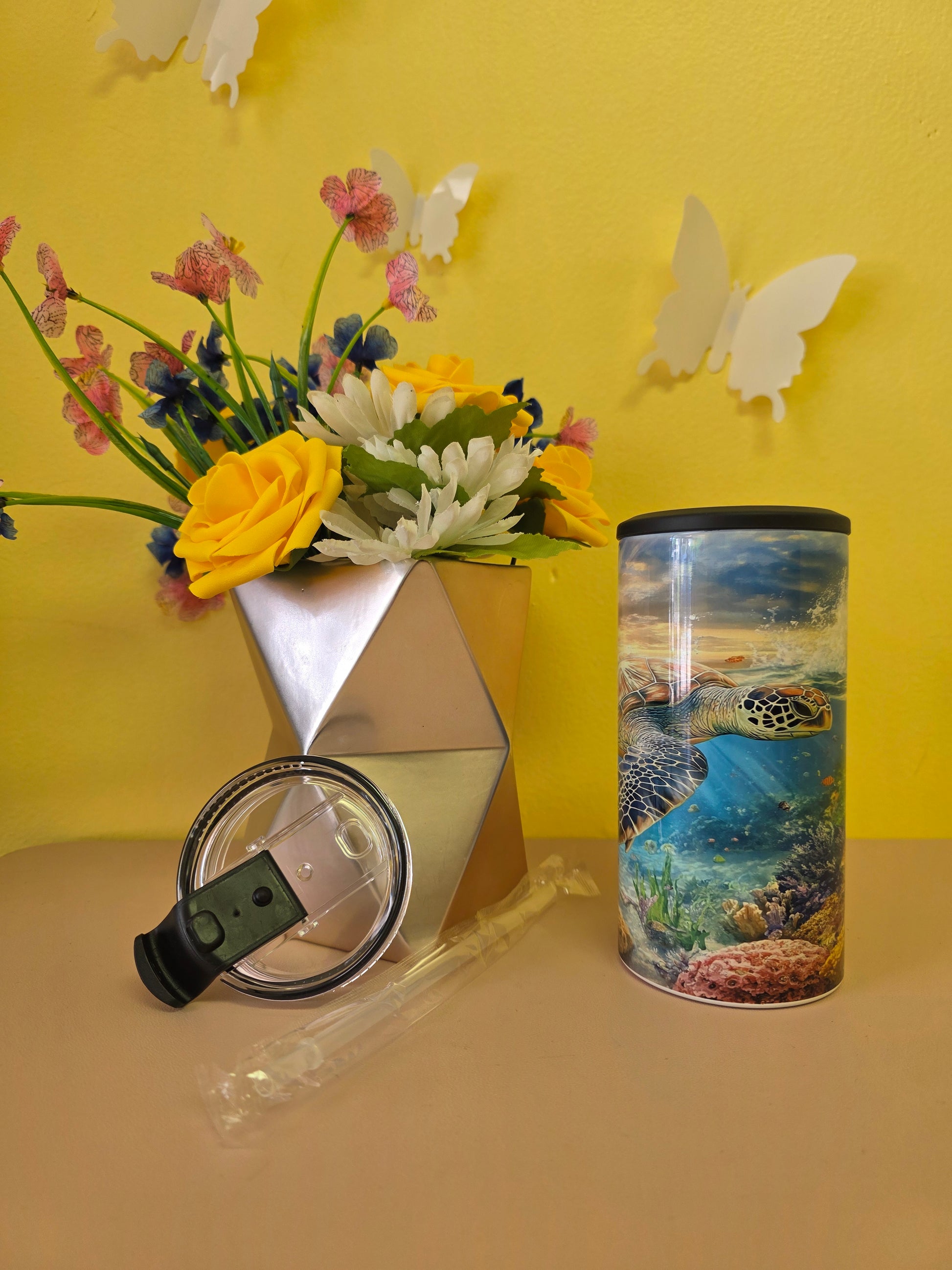 4‑in‑1 insulated stainless steel tumbler with sea turtle ocean design, shown with lid, straw, and floral decor