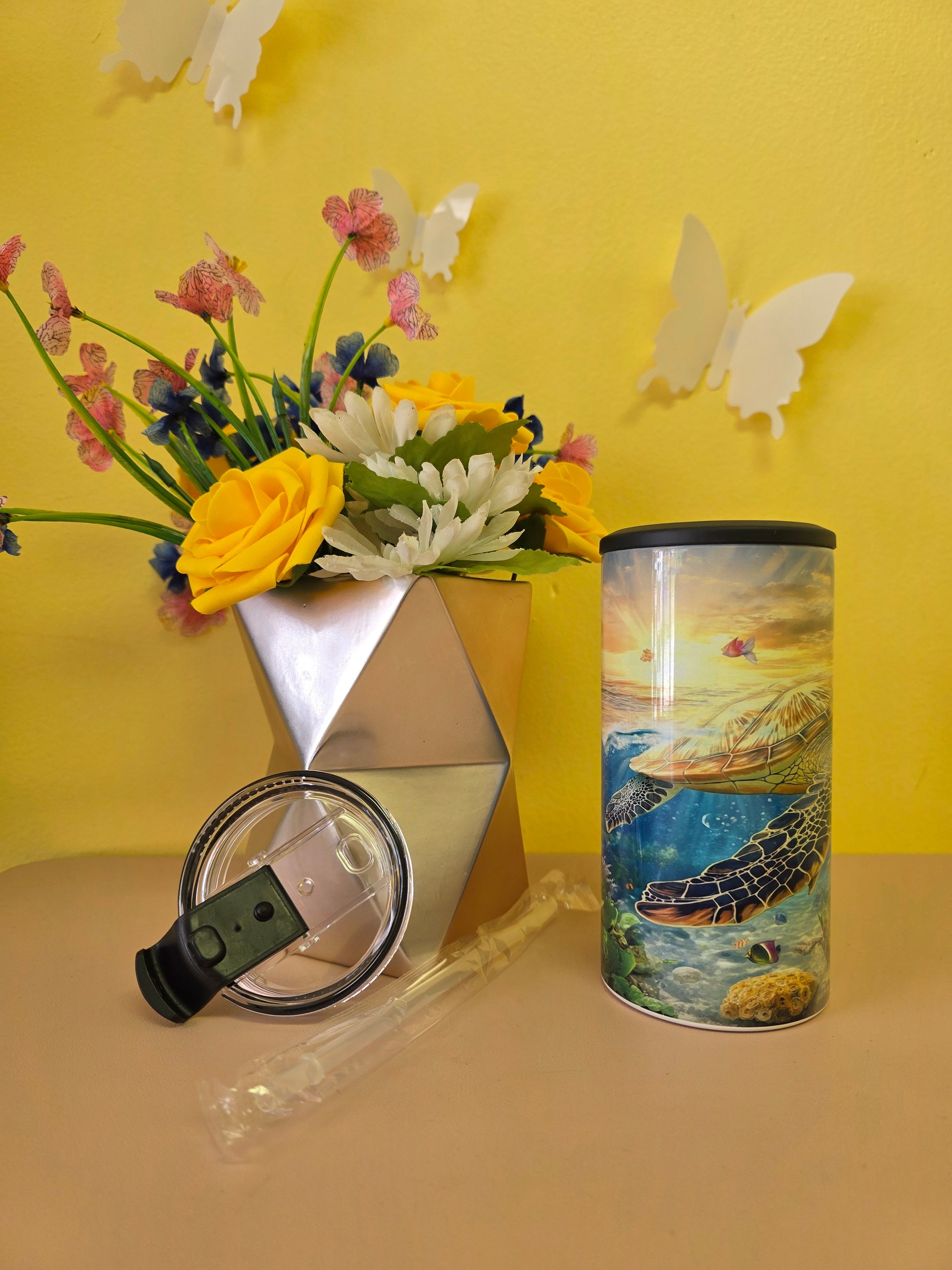 4‑in‑1 insulated stainless steel tumbler with sea turtle ocean design, shown with lid, straw, and floral decor