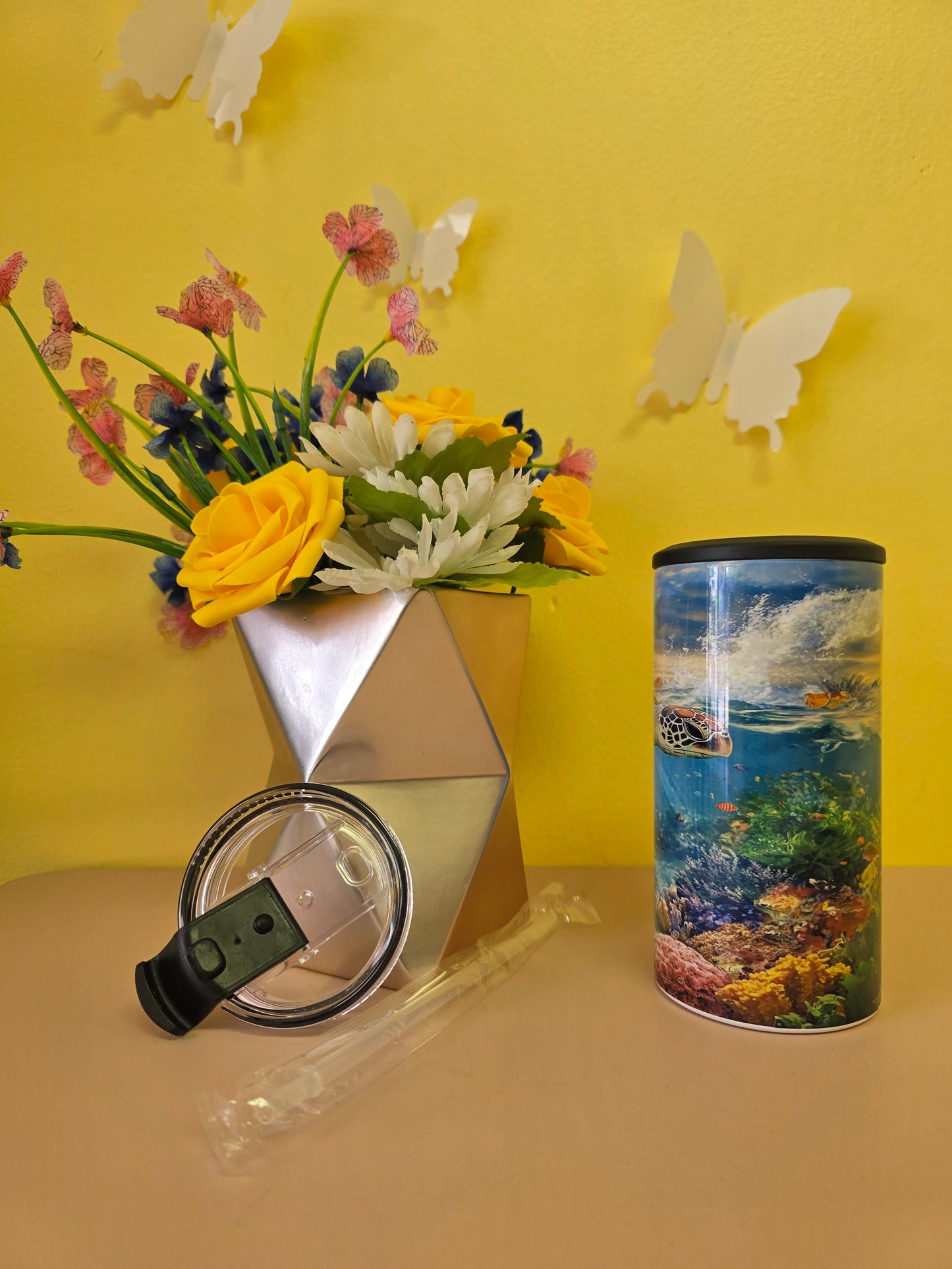 4‑in‑1 insulated stainless steel tumbler with sea turtle ocean design, shown with lid, straw, and floral decor