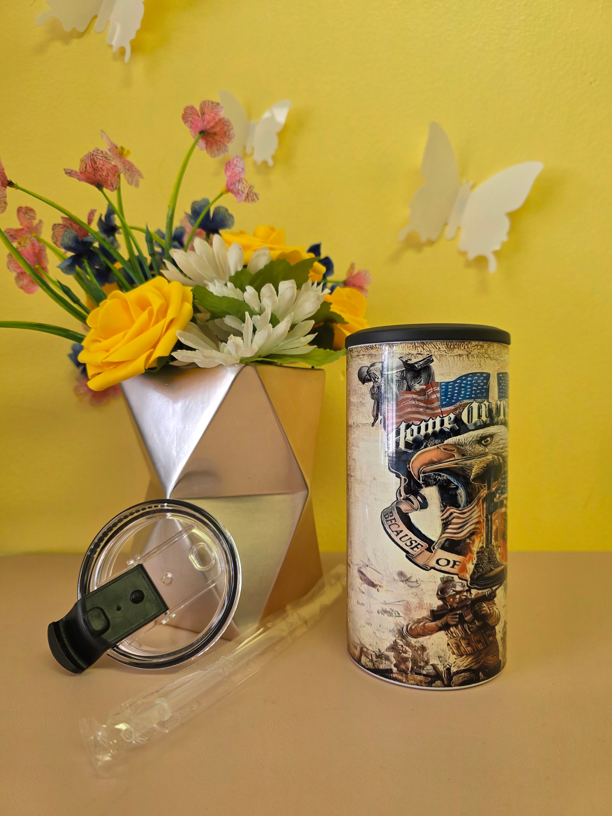 4‑in‑1 insulated stainless steel tumbler with rustic Veterans American flag design, shown with lid, straw, and patriotic decor