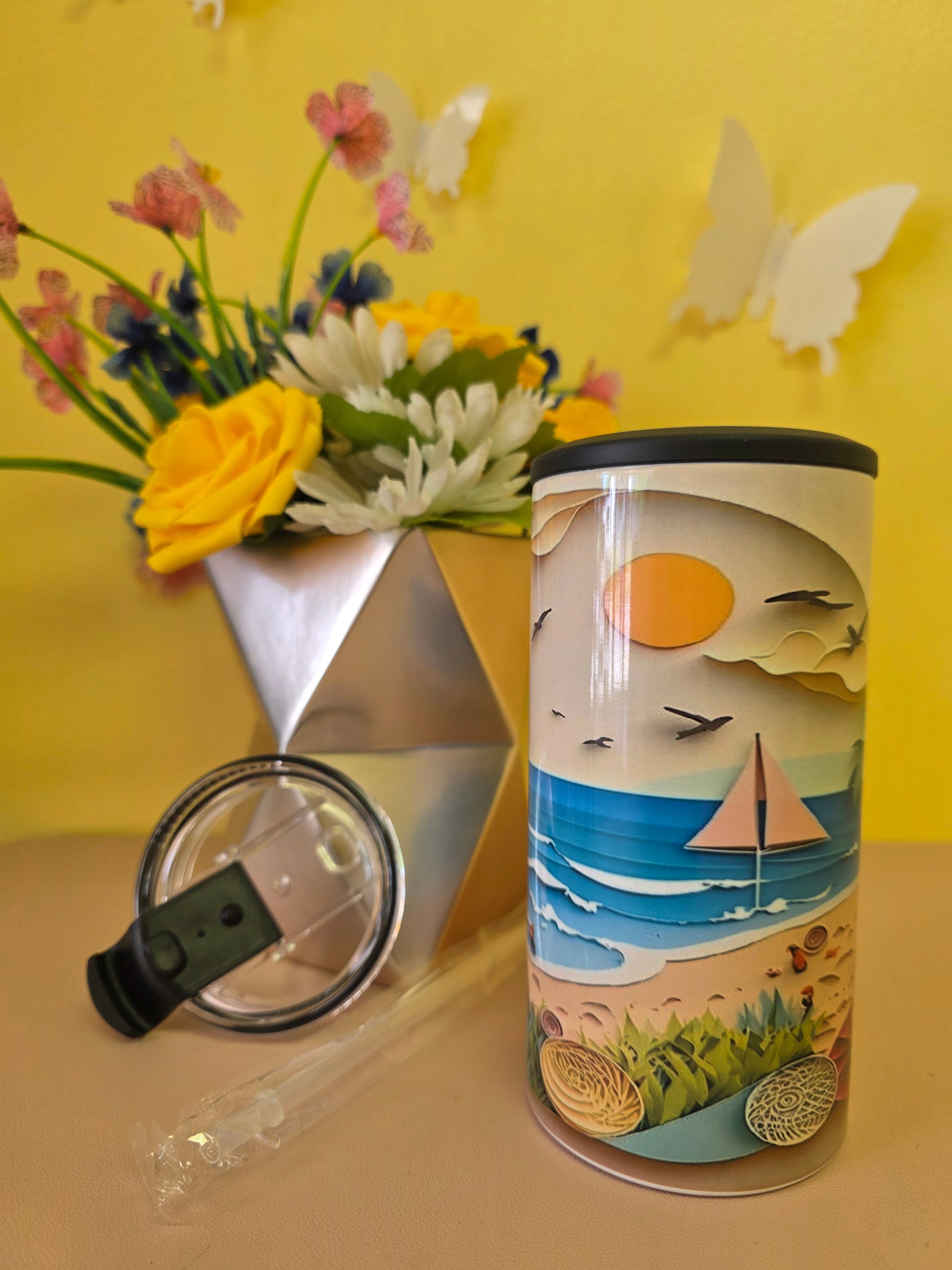 4‑in‑1 insulated stainless steel tumbler with clay‑style beach scene featuring sun, sailboat, waves, and seashells