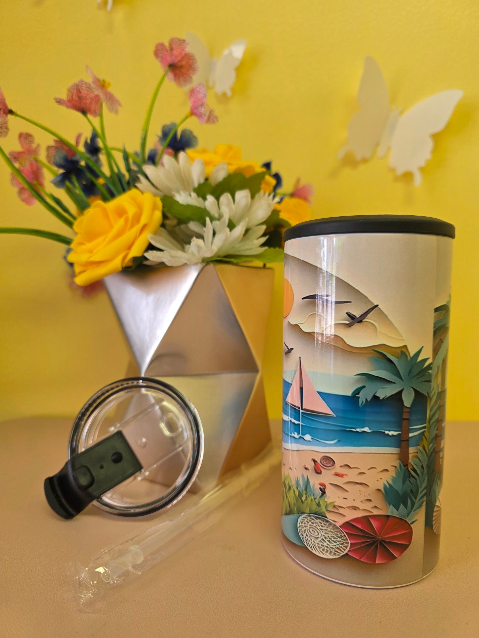4‑in‑1 insulated stainless steel tumbler with clay‑style beach scene featuring sun, sailboat, waves, and seashells