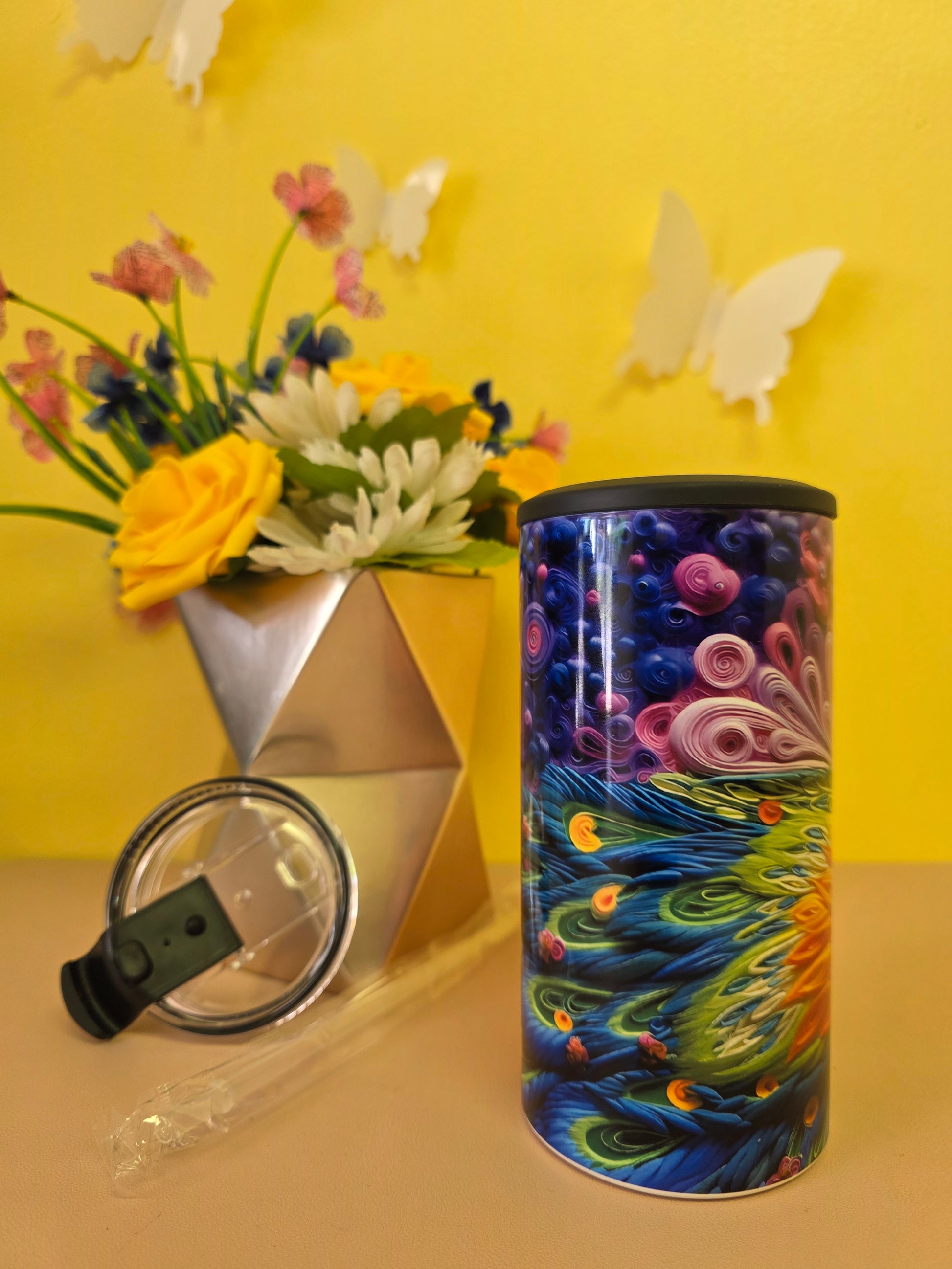 Insulated 4‑in‑1 stainless steel tumbler with vibrant multicolor floral design, shown with lid, straw, and flower arrangement
