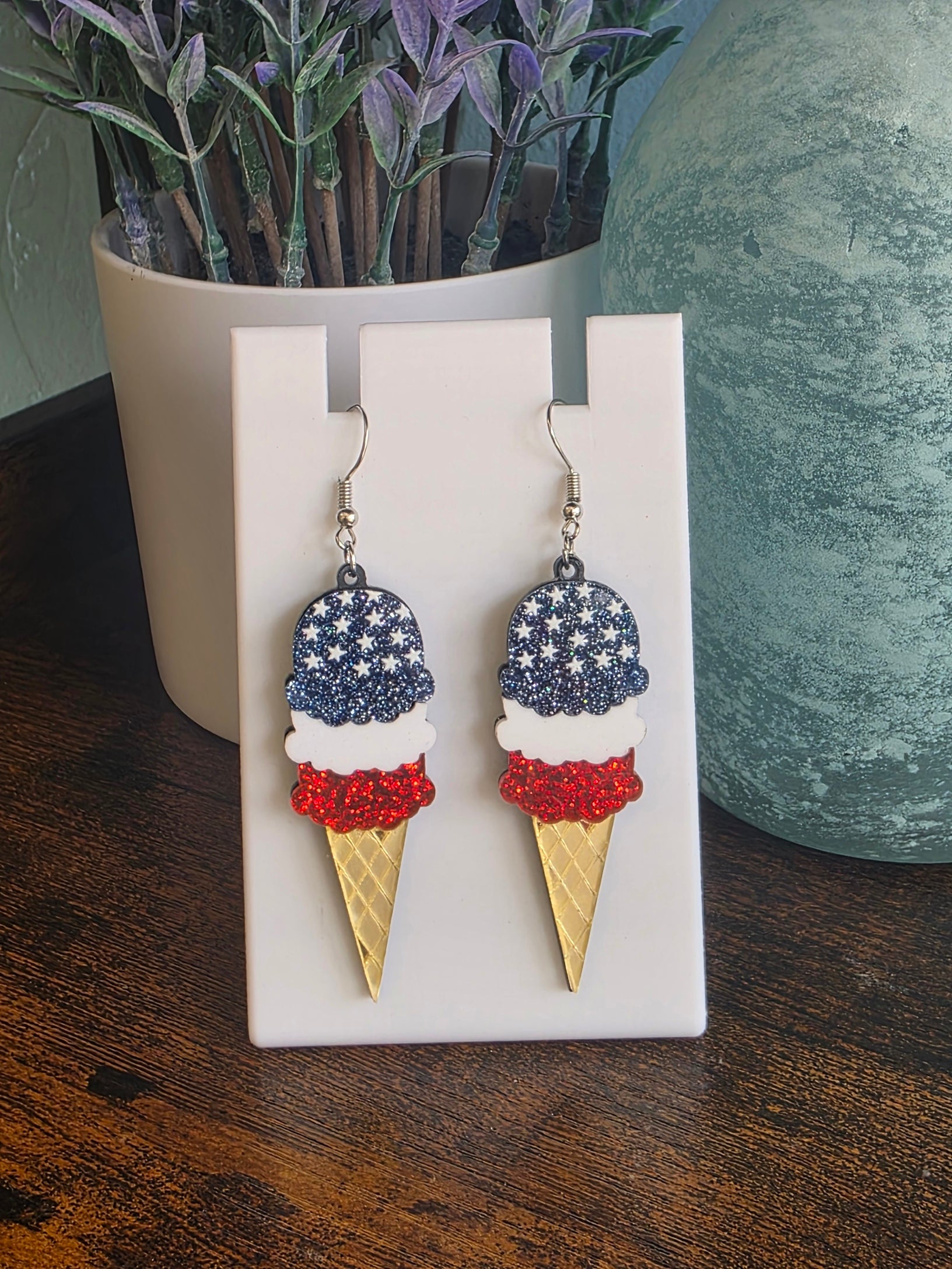 Ice cream cone earrings with American flag design on a white stand Independence Day