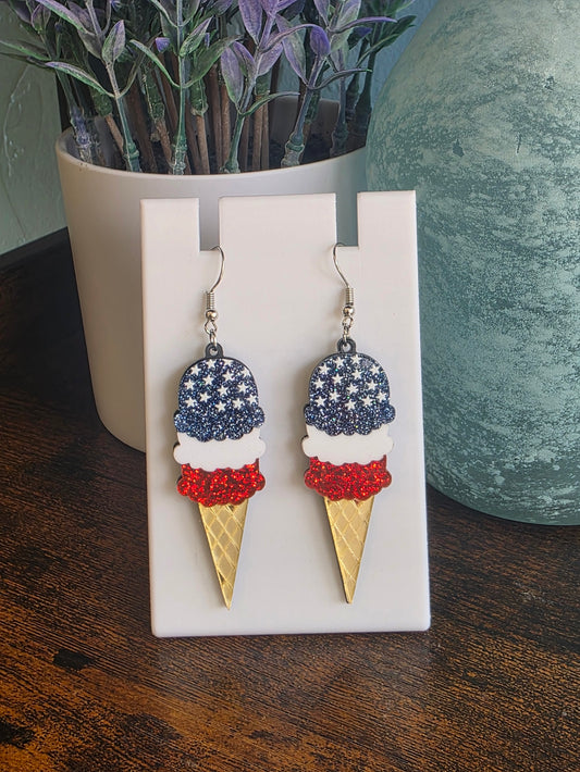 Ice cream cone earrings with American flag design on a white stand Independence Day