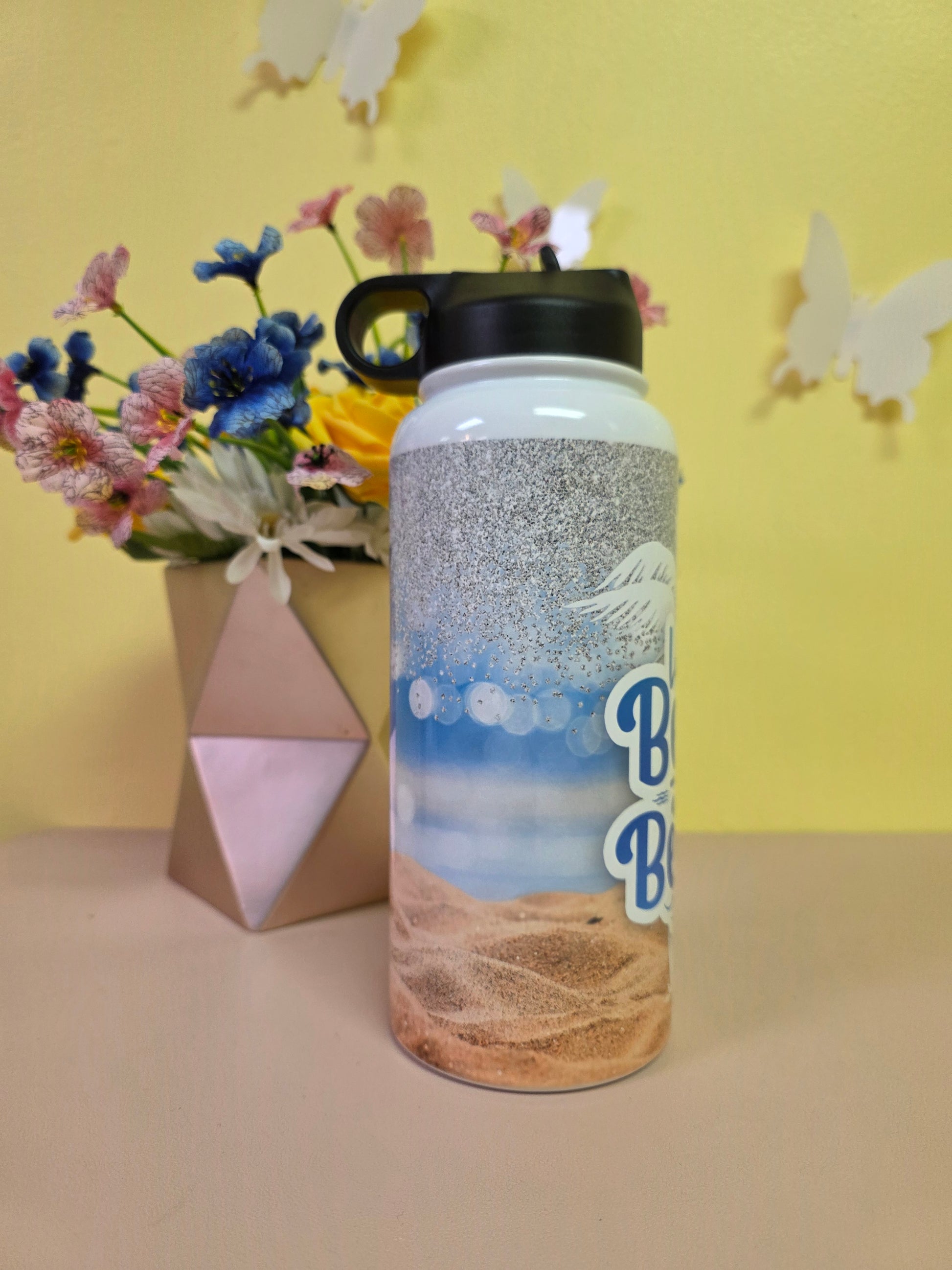 Tumbler with floral arrangement and geometric box on a yellow background