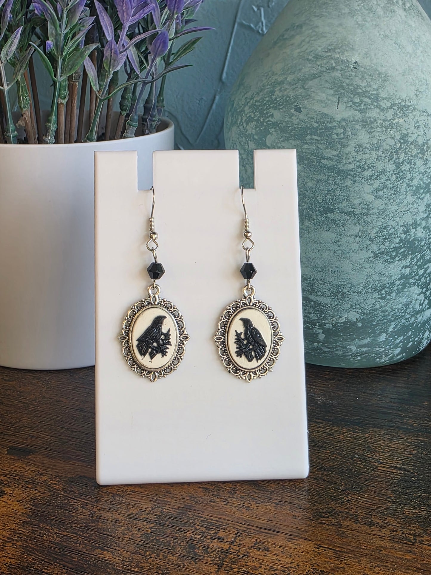 Pair of gothic earrings of a black crow with white background