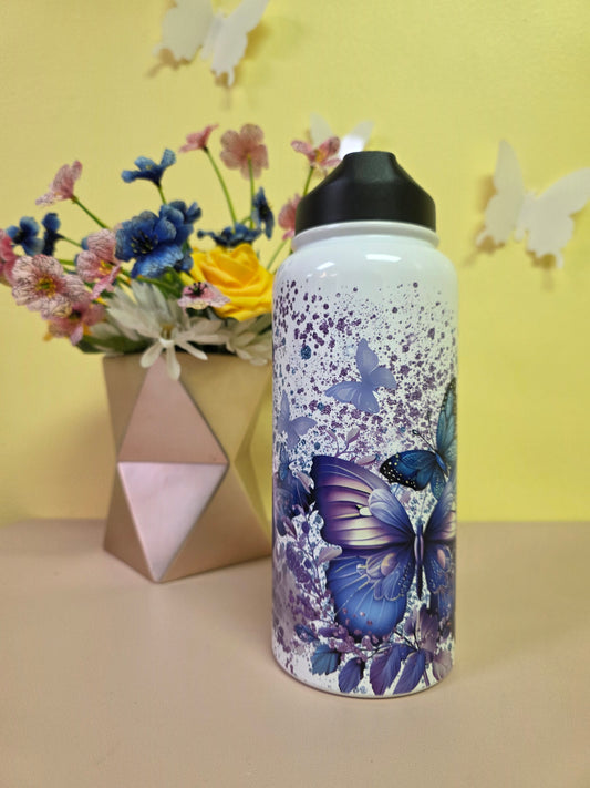 Floral-patterned water bottle on a yellow surface with flowers and a box.