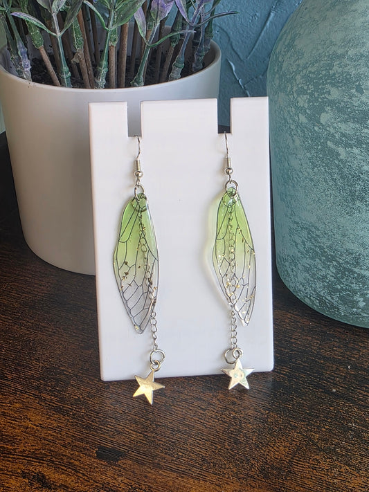 Pair of lightweight butterfly wing earrings with a silver star dangle.