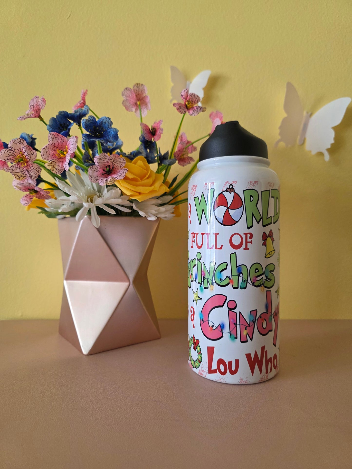 How the Grinch Stole Christmas Cindy Lou Who Stainless Steel Water Bottle on a table with yellow background