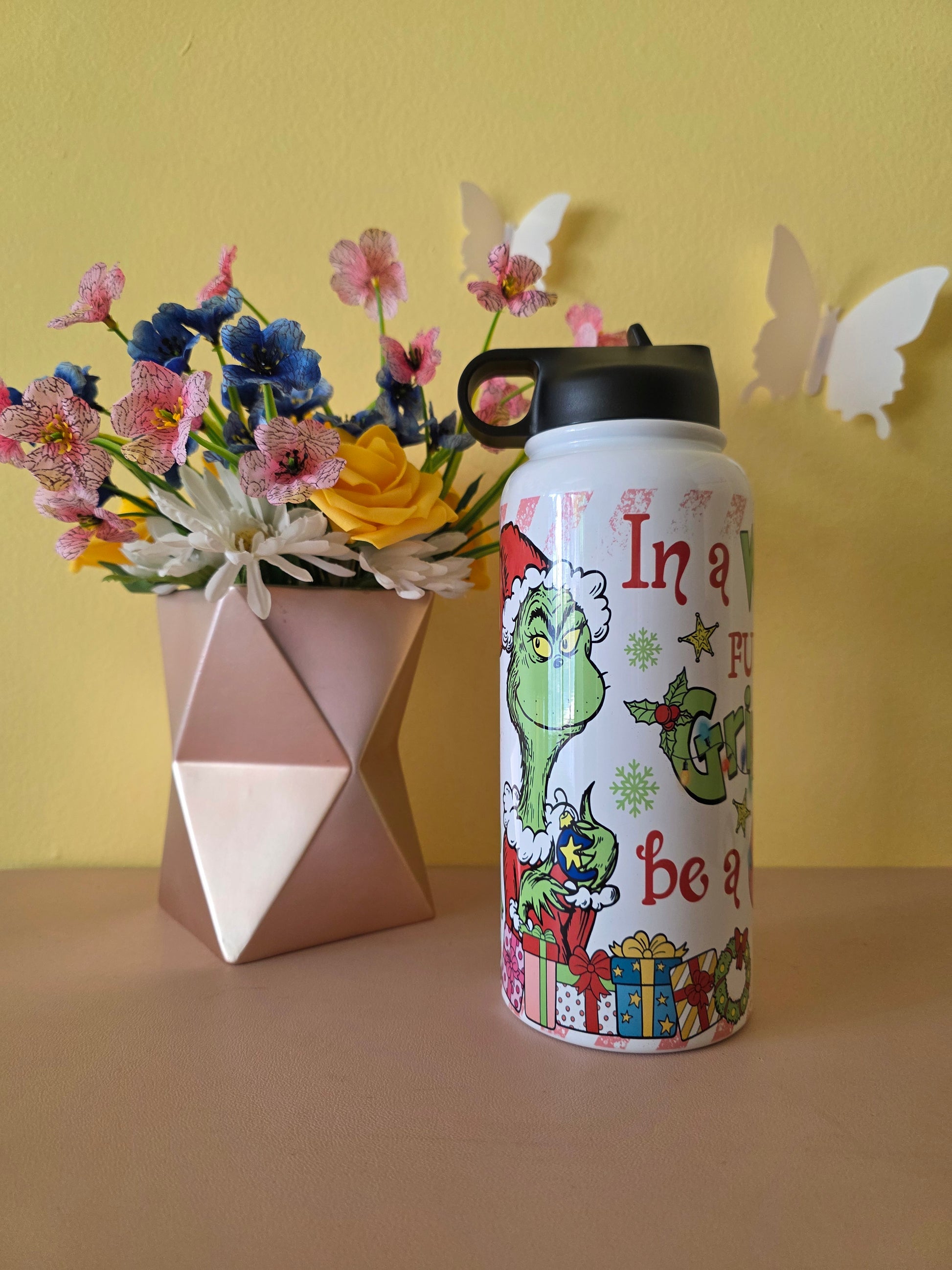 How the Grinch Stole Christmas Cindy Lou Who Stainless Steel Water Bottle on a table with yellow background