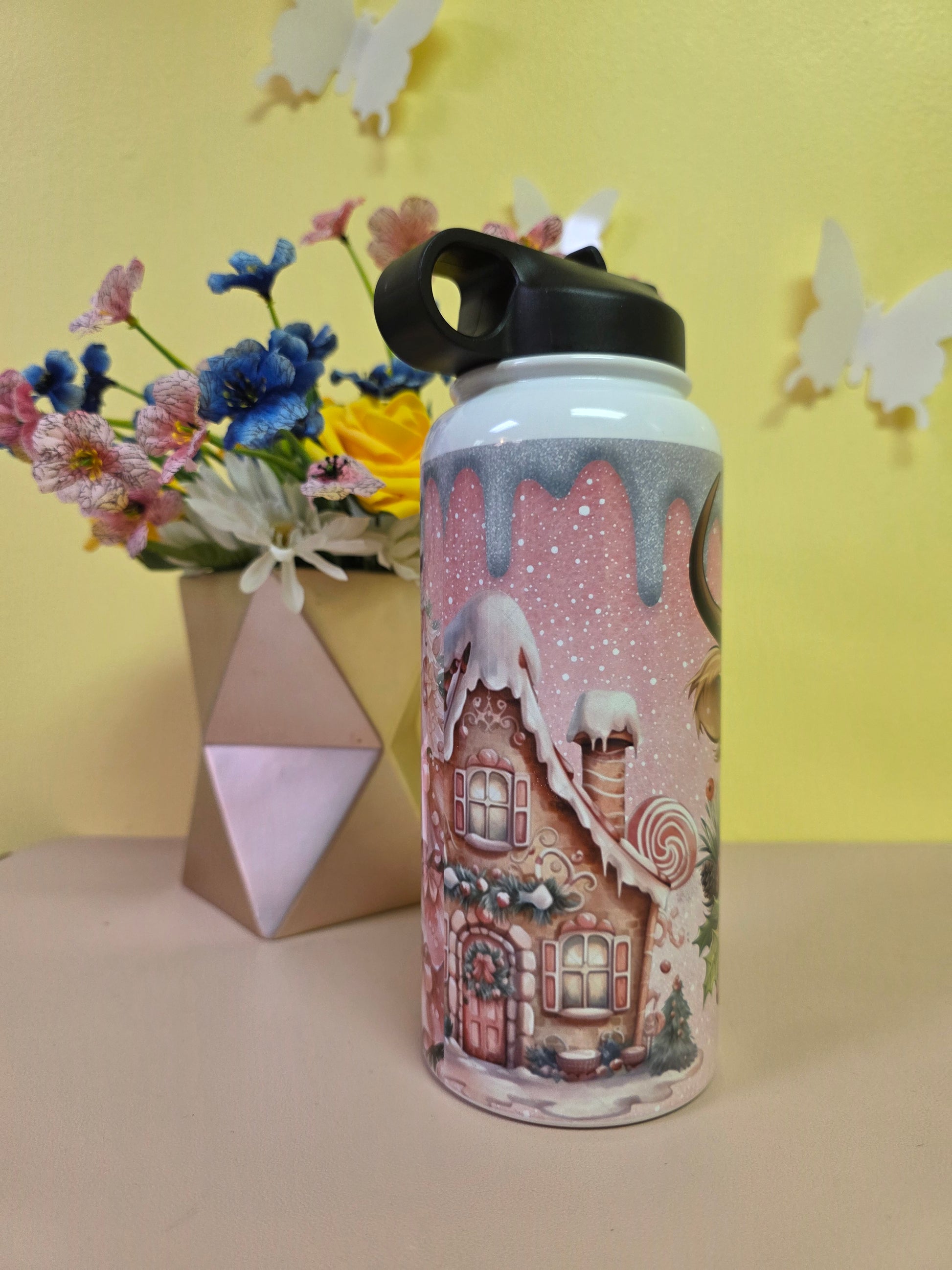 Decorative mug with gingerbread house design on a yellow background