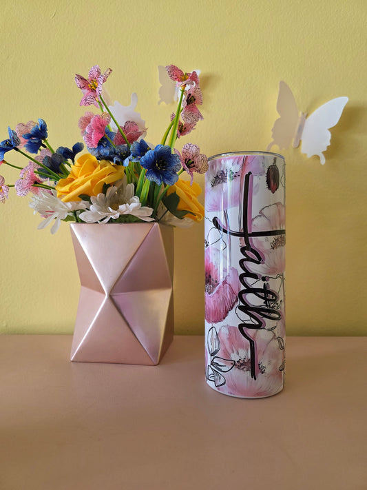 Decorative tumbler with 'Faith' text, colorful flowers, and a butterfly on a yellow background