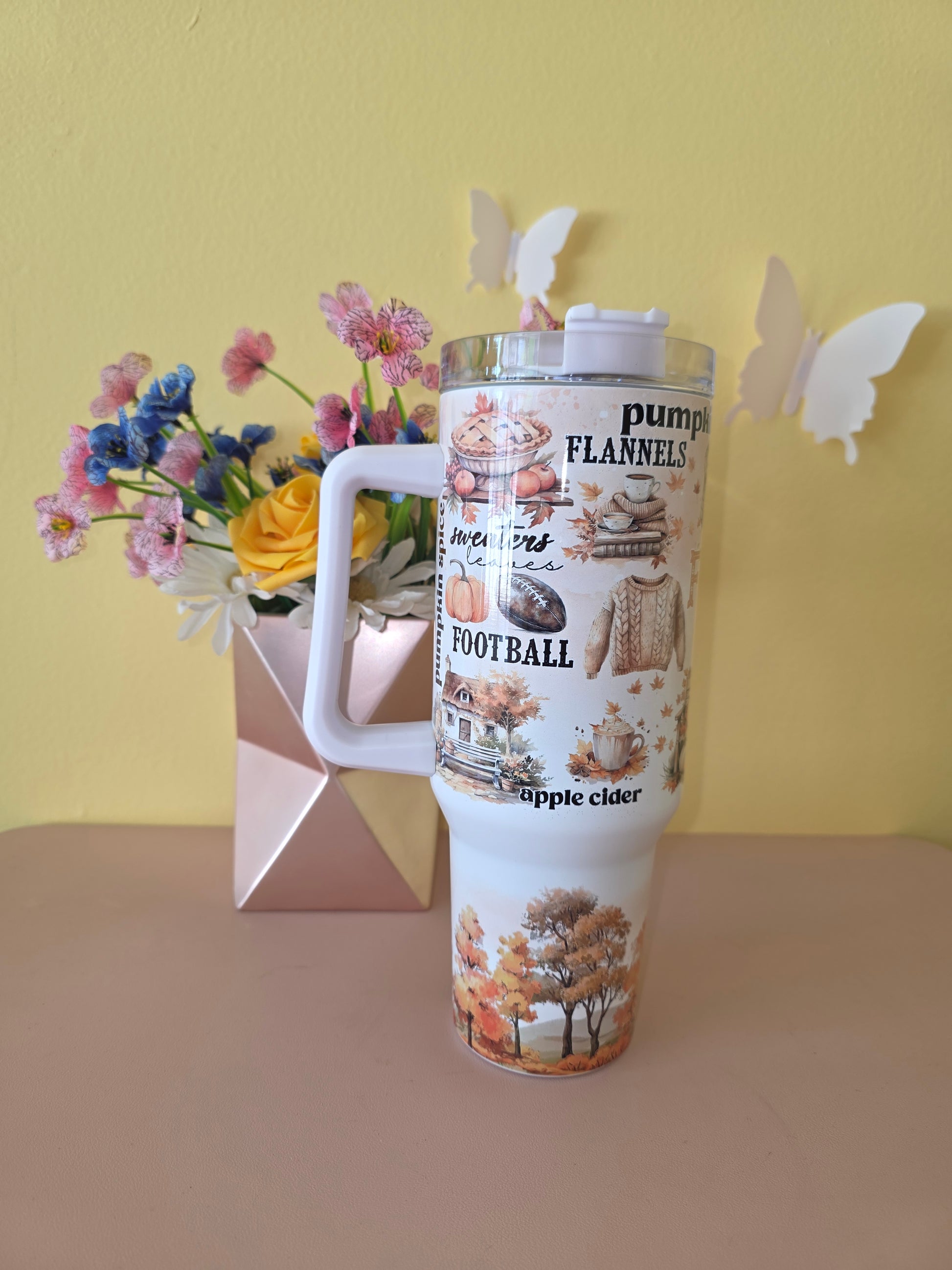 Fall Vibes 40 ounce tumbler on a pink table with yellow background