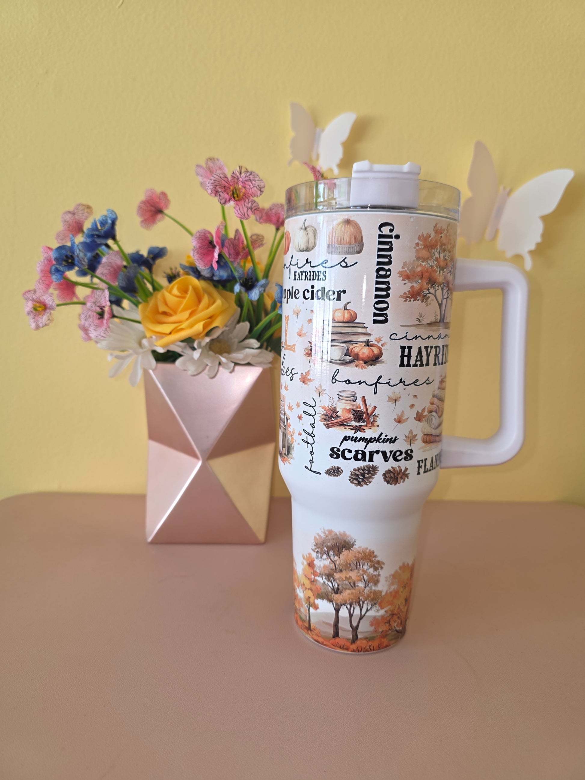 Fall Vibes 40 ounce tumbler on a pink table with yellow background
