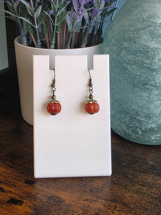 Pair of antique style pumpkin earrings with bronze finishes.