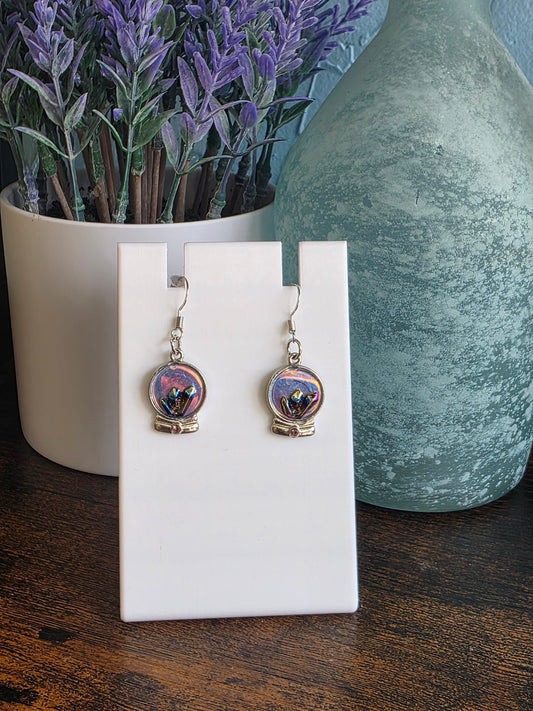 Pair of earrings showing a crystal ball 