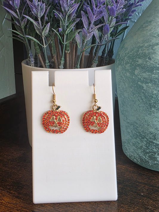 Orange jeweled jack o' lantern earrings with gold details