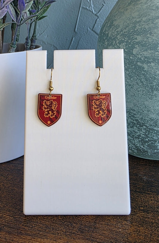 Harry Potter Gryffindor House earrings in gold finishes.
