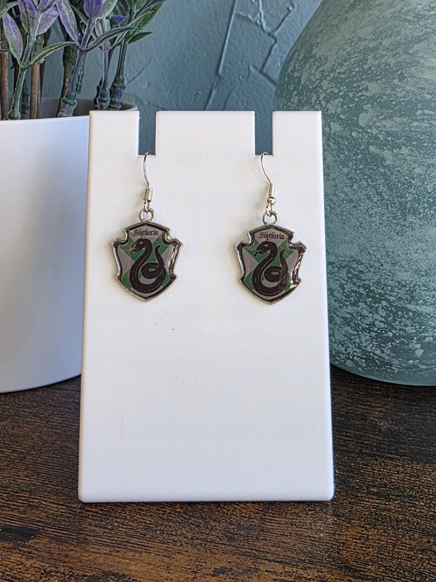 Harry Potter Slytherin house earrings with silver finishes.