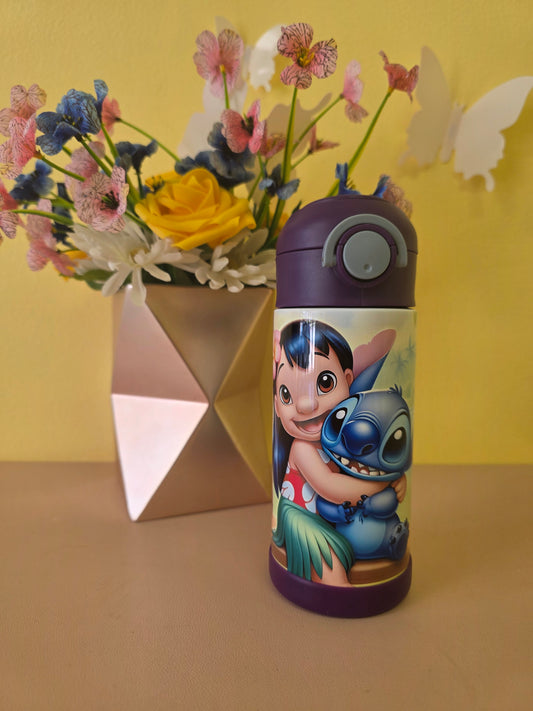 Lilo and Stitch tumbler on a table with flowers in the background. 