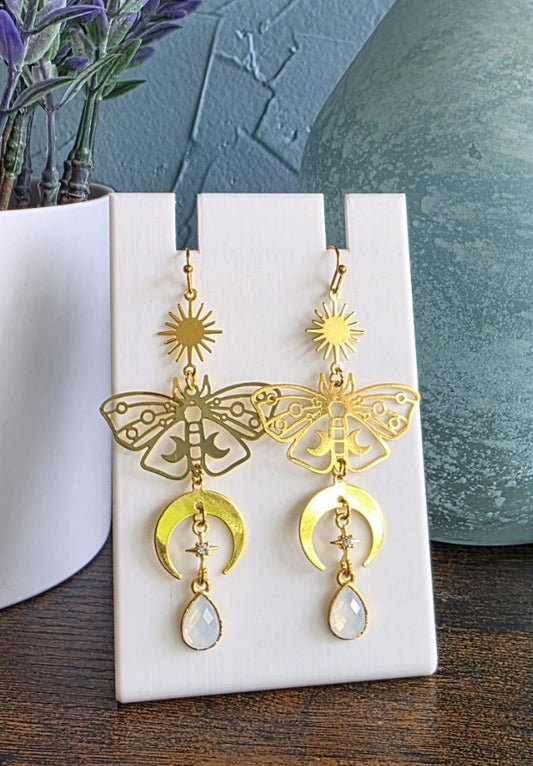 Gold butterfly dangle earrings with mystical design