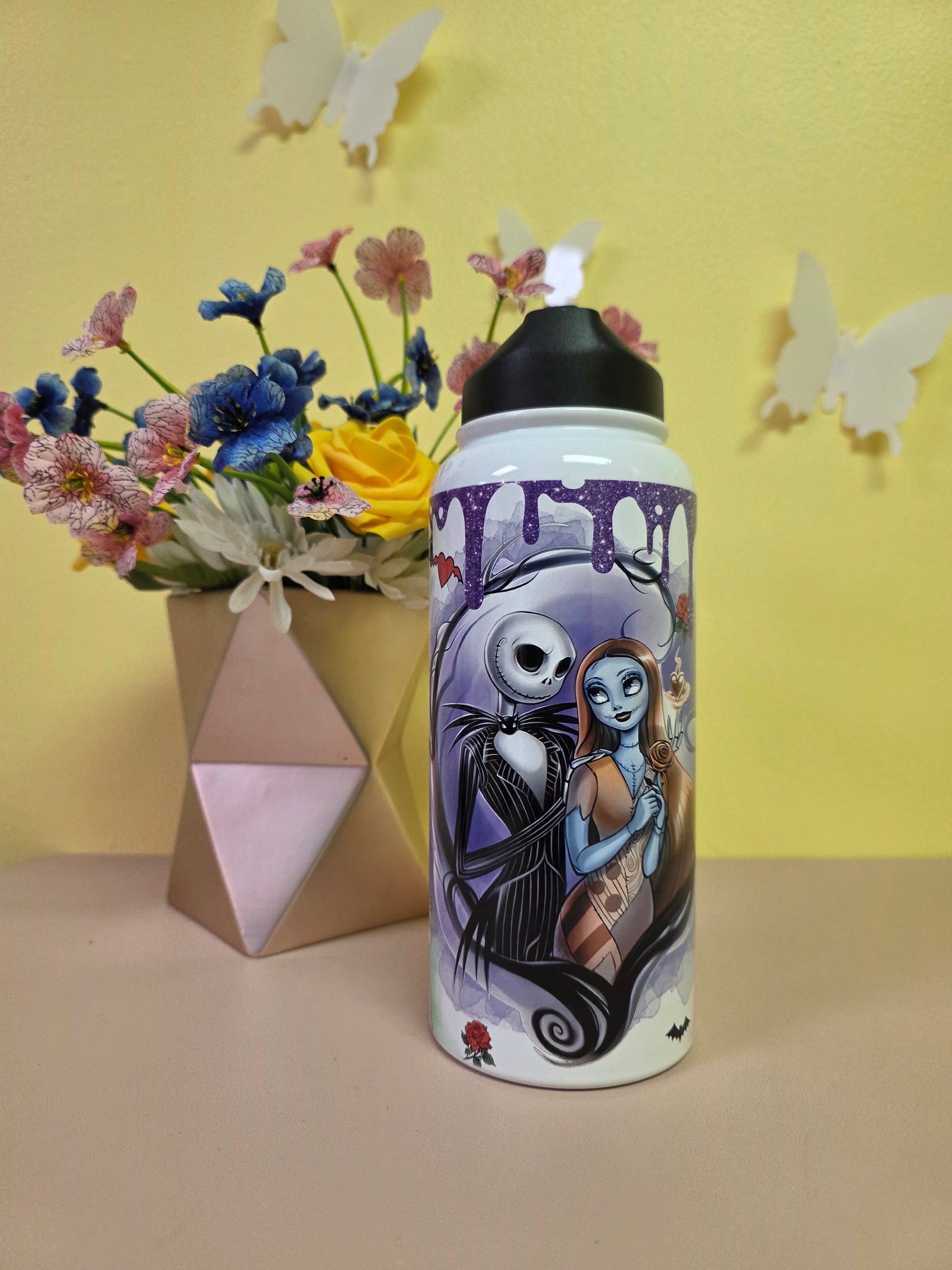 Water bottle with a design of a couple on a yellow and beige background with flowers.
