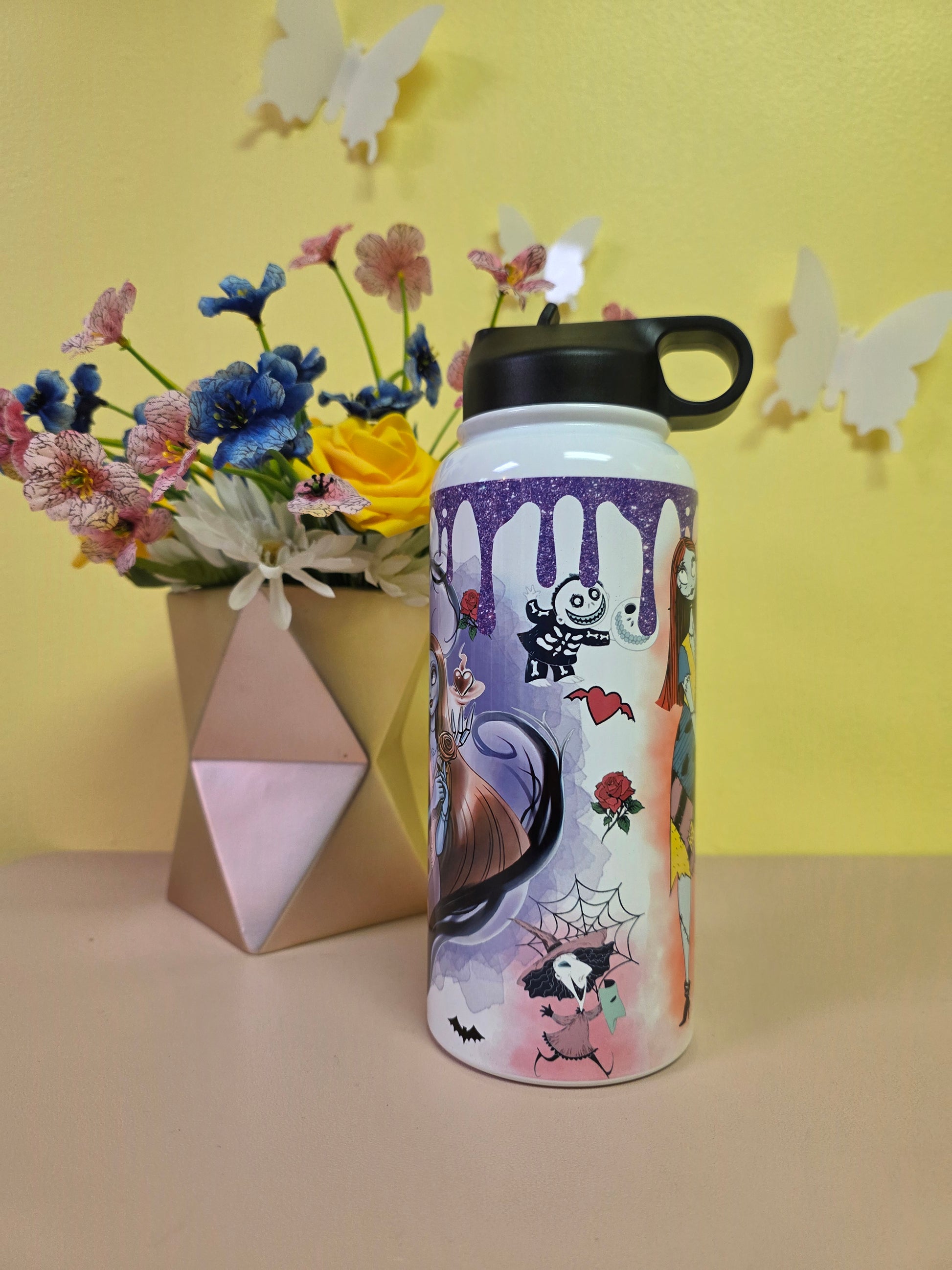 Colorful water bottle with cartoon design on a yellow background