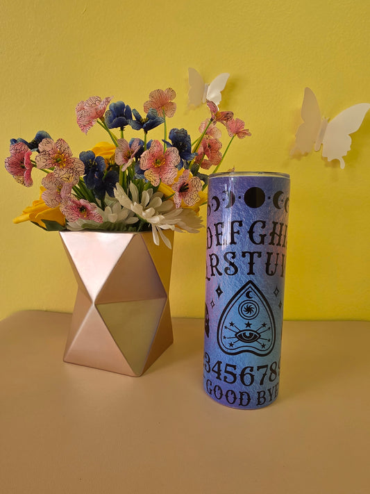 Decorative cylindrical object with text and a geometric vase on a yellow background
