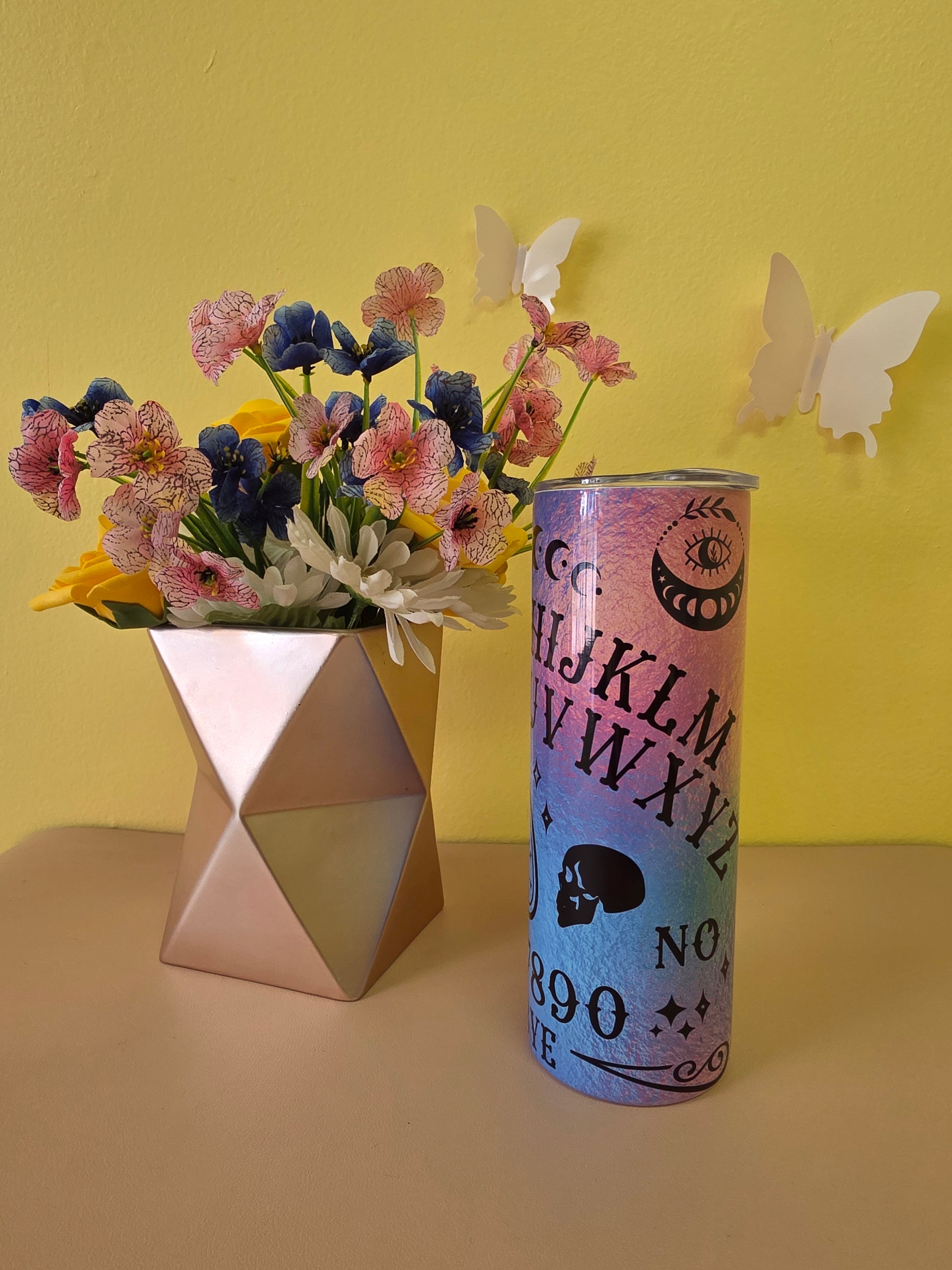 Colorful cylindrical container with text and flowers on a yellow background