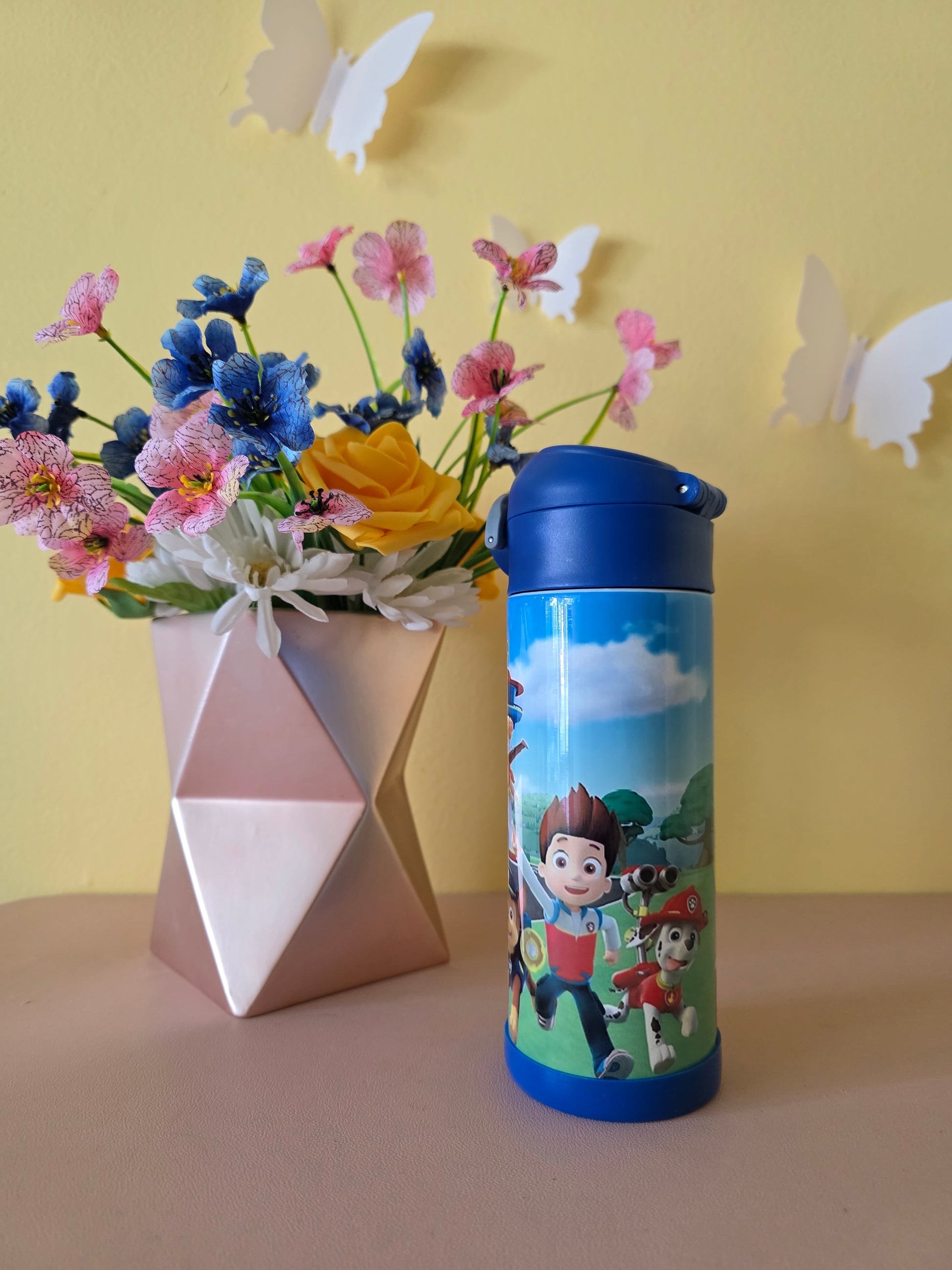Paw Patrol Kids Tumbler on a table with yellow background